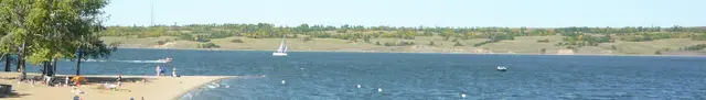 Beach and sailboat on Last Mountain Lake
